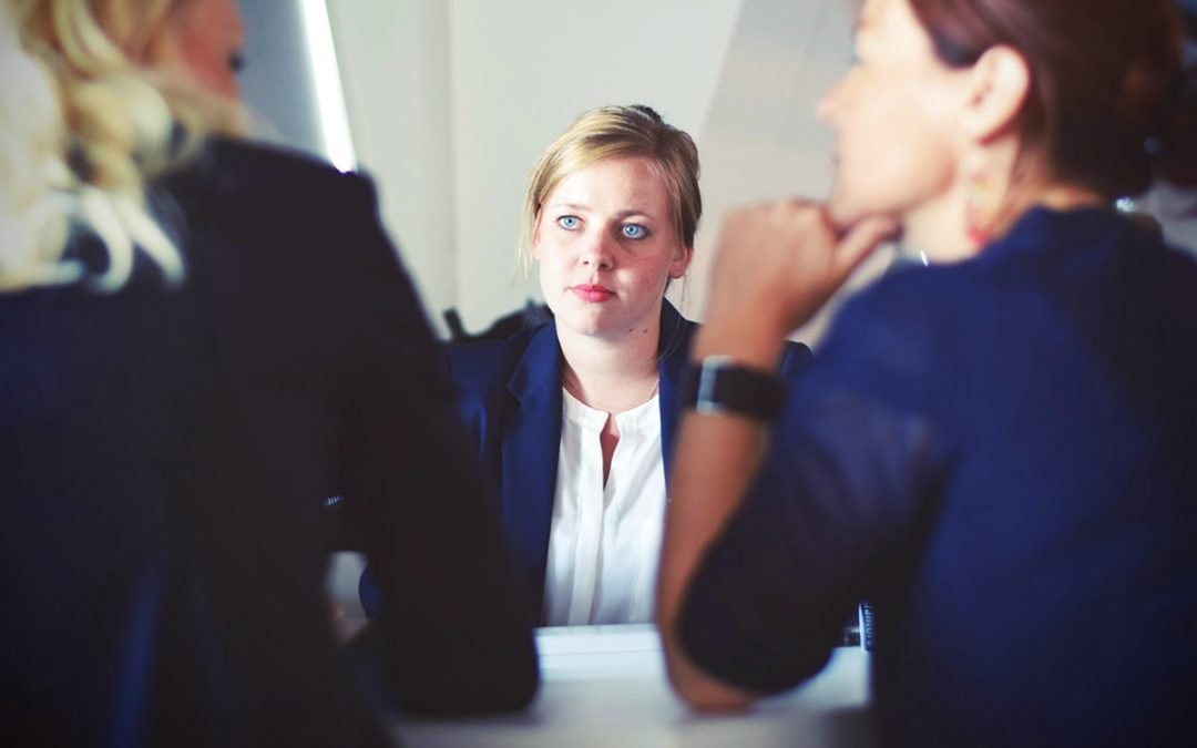 Three women having a difficult conversation about drug use at work.