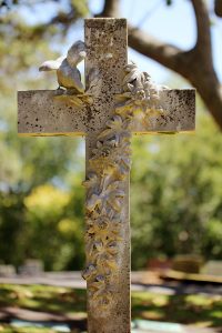 A white cross is shown in a cemetery at a funeral for a teen who died of a fentanyl overdose.